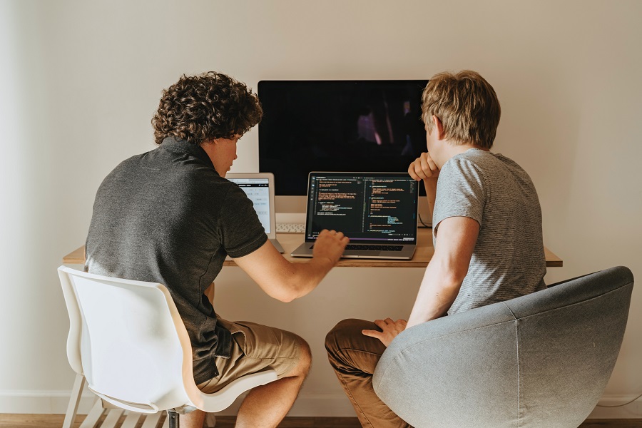 Two men working at computer desk